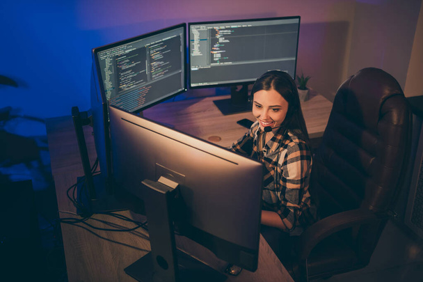 Photo of hard-working software developer in headset smiling toothily looking into screen using connection programs to speak - Foto, immagini