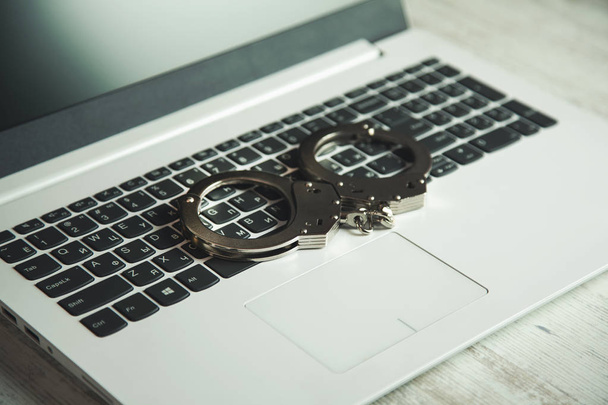 handcuffs on keyboard - Photo, Image