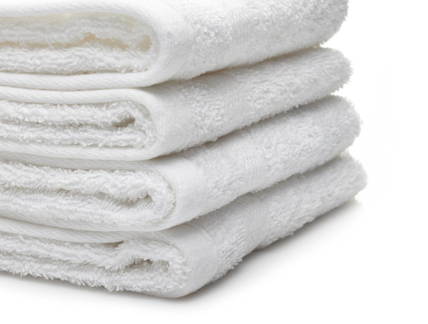 Stack of white hotel towels on a white background - Valokuva, kuva