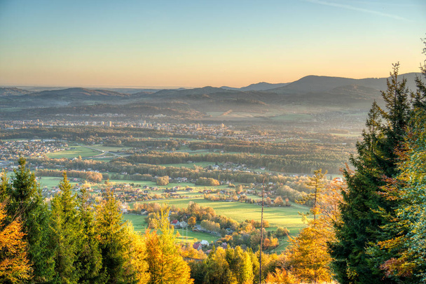 view of a valley full of industry that smokes and house from the mountain at sunrise in autumn , czech , trinec - Zdjęcie, obraz