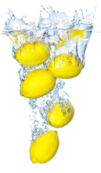 Яскраво-жовті лимони і бризки води
 - Фото, зображення