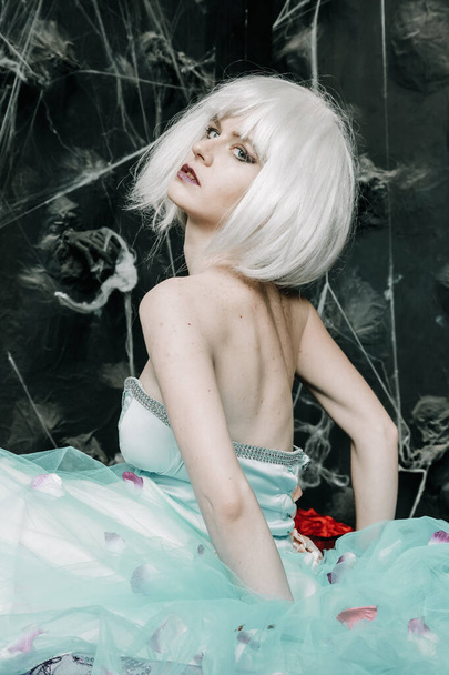 Young glamour girl doll in white wig and blue dress posing alone - Фото, зображення