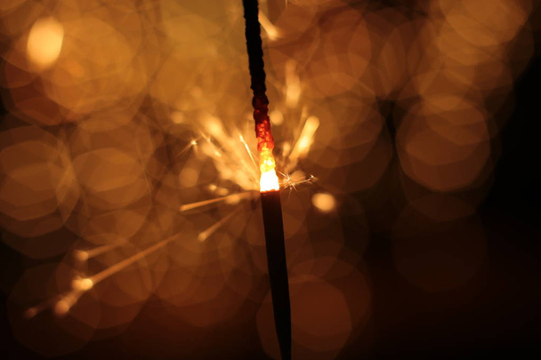 Bengal fire and sparks macro photo festive bokeh background Christmas and New Year - Photo, Image
