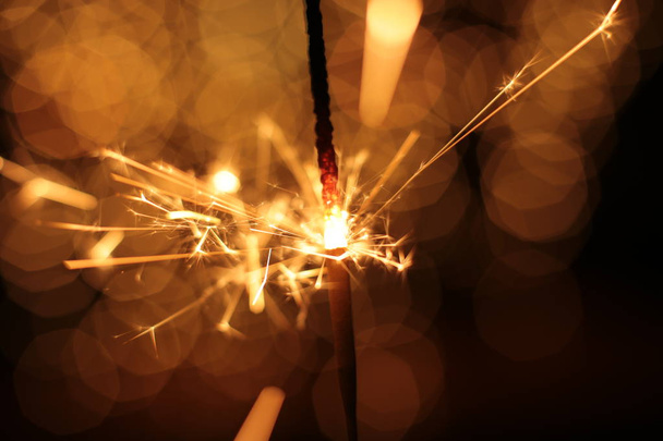 Bengal fire and sparks macro photo festive bokeh background Christmas and New Year - Foto, Bild