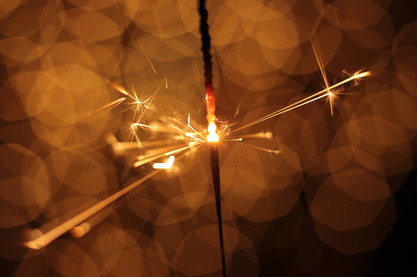 festive sparkling  flashing bokeh background Christmas and New Year and sparkler - Foto, imagen