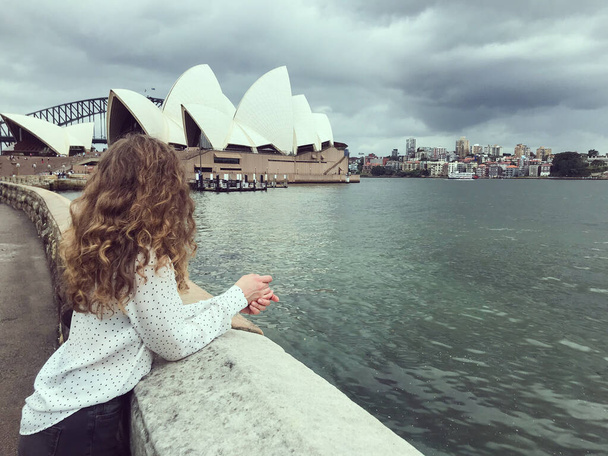 Curly hair girl enjoying view on Sydney Opera - 写真・画像