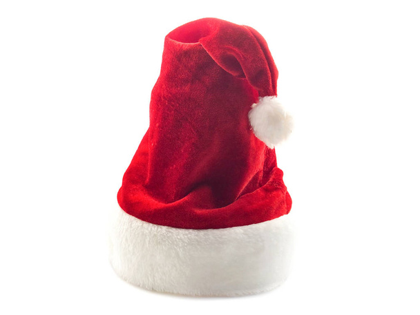 Red Santa Claus hat isolated on a white background. Wicked hat for the new year. Festive fluffy hat for winter. - Photo, Image
