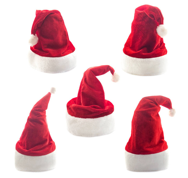 Red Santa Claus hat isolated on a white background. Wicked hat for the new year. Festive fluffy hat for winter. - Photo, Image