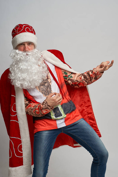 amazing man in a Santa Claus hat danced crazy dances. - Fotó, kép
