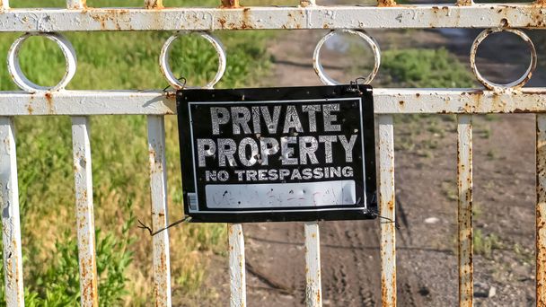 Panorama frame Private Property sign on an old rusty white gate locked with chain and padlock - Photo, Image