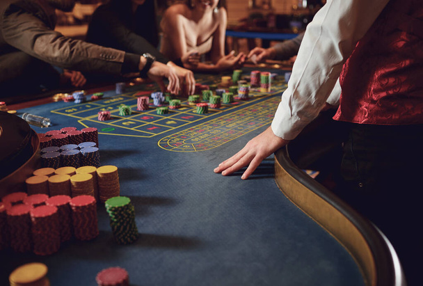 People gambling at roulette poker in a casino. - Фото, изображение