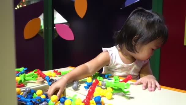 cute little Asian girl playing in child room - Felvétel, videó