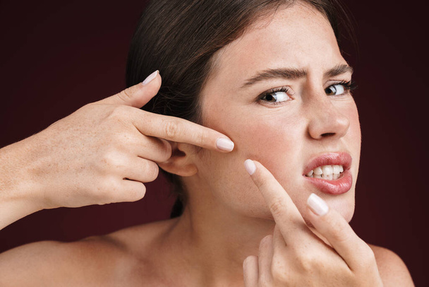 Image of confused shirtless woman squeezing out pimples - Photo, Image
