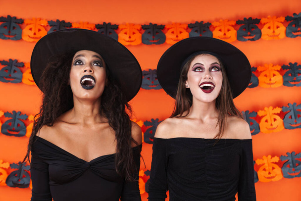 Image of pretty witch women in black halloween costume looking u - Zdjęcie, obraz