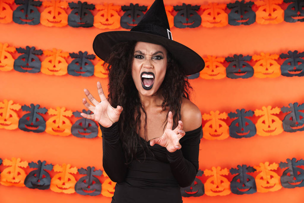 Image of witch girl in black halloween costume screaming and scr - Foto, Imagem