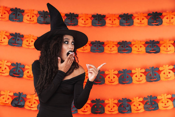 Image of witch woman in black halloween costume pointing finger  - Φωτογραφία, εικόνα