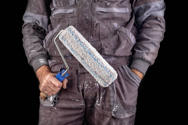 Painter holding paint rollers in his hand.  - Фото, зображення