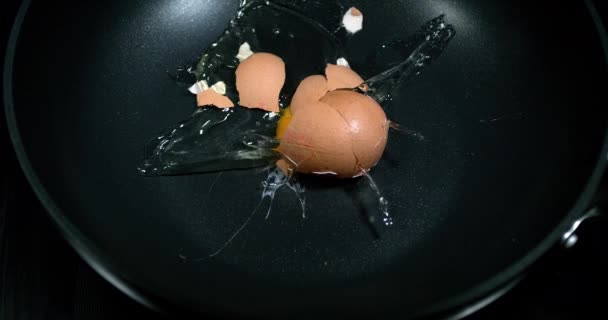 Egg bursting into a stove, slow motion 4K - Footage, Video