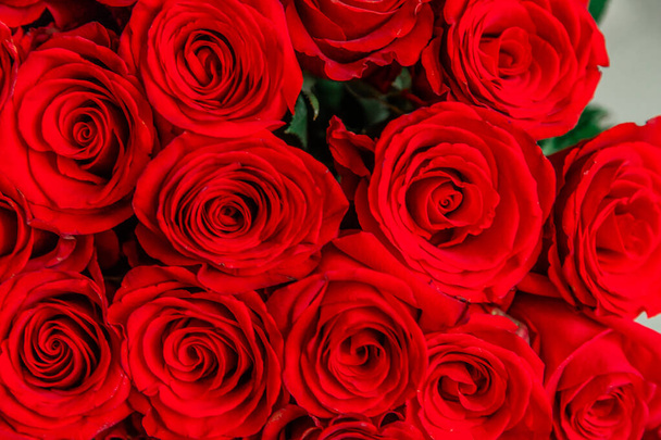 Cropped top-view photo of bouquet of big tender red roses. - Foto, imagen