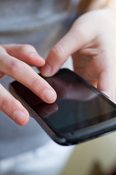 Girl hand touching screen on smart phone - Photo, Image