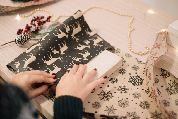 Girls hands packing Christmas present with wrapping paper - Φωτογραφία, εικόνα