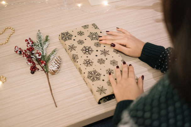 Christmas presents wrapping and artificial twig on desk - Φωτογραφία, εικόνα