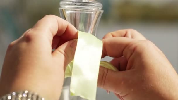 Tying a cloth tape on a glass vase - Felvétel, videó