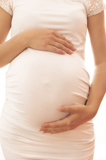 La femme enceinte sur fond blanc
 - Photo, image
