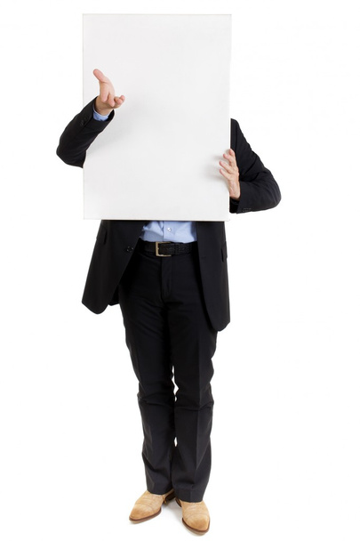 Businessman with a blank sign in front of his face - Photo, Image