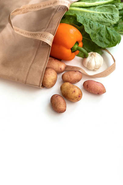 Null Abfall weniger Kunststoffkonzept / frisches Gemüse Bio in Öko-Baumwollstofftaschen auf Holztisch - weiße Stofftasche mit Tragetuch vom Markt - Foto, Bild
