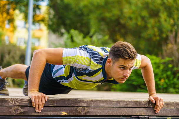 Man doing push ups outdoor - Fotó, kép