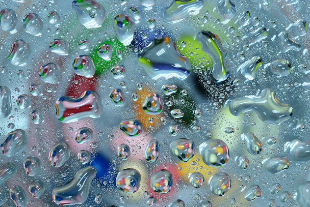 Gota de agua colorida sobre fondo de vidrio
 - Foto, imagen