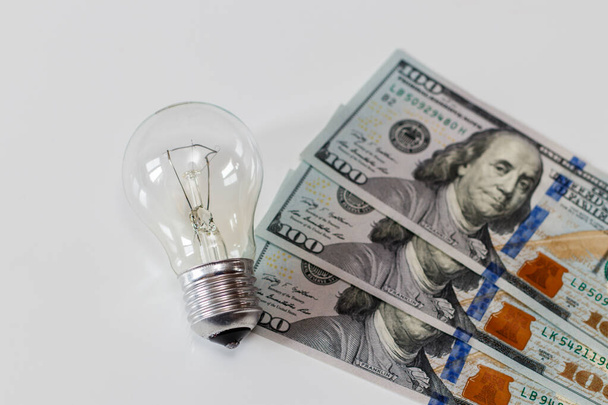 Lamp on white table and dollars. - Fotó, kép