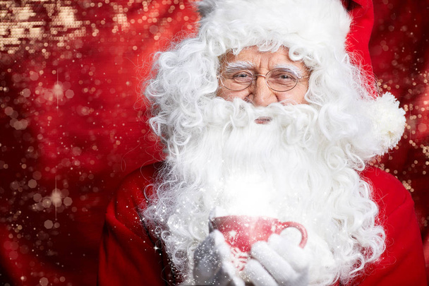 Santa Claus drinking tea Closeup Portrait Isolated on red - Foto, Imagen