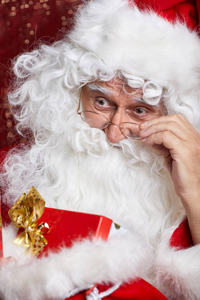 Santa Claus drinking tea Closeup Portrait Isolated on red - Valokuva, kuva