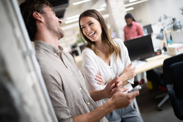Cheerful coworkers in office during company meeting - Photo, image