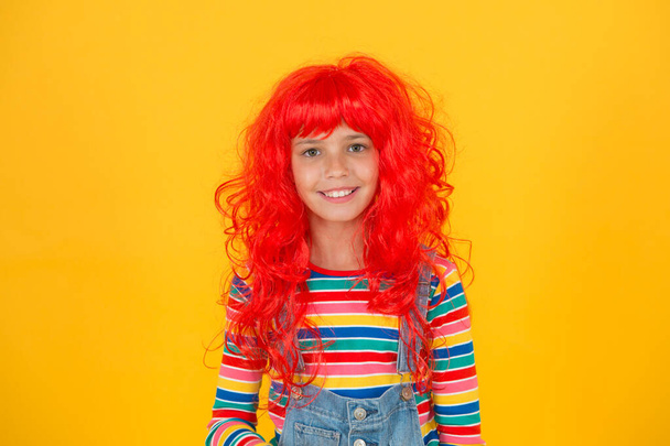 My hair speak for itself. Funny kid with red synthetic hair. Happy small child wear long hair wig. Cute little girl smile with fancy hair style. Beauty and fashion - Foto, Bild