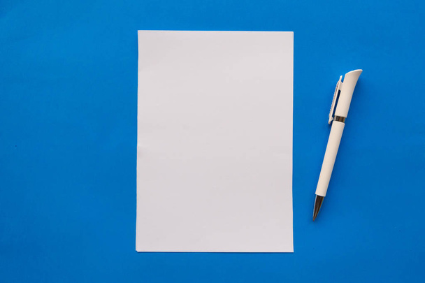 White mockup blank and pen on blue background - Fotó, kép