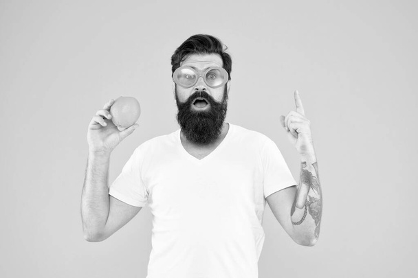 Healthy orange recipe idea. Hipster with genius idea pointing finger up on yellow background. Bearded man got bright idea for natural dieting. Super food idea - Valokuva, kuva