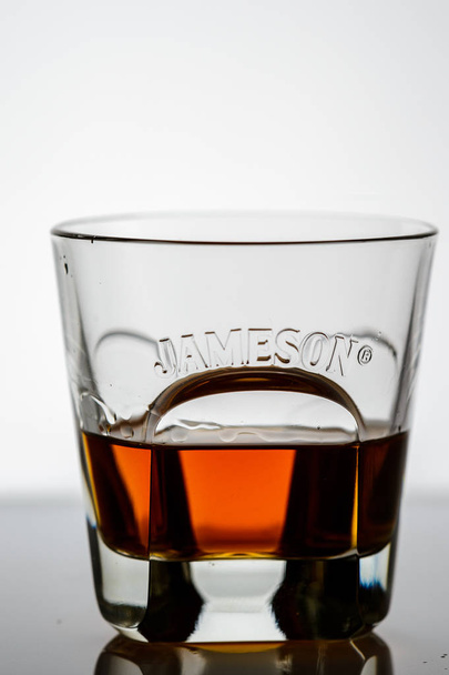 splashing whiskey in a glass on the background15 - Photo, Image