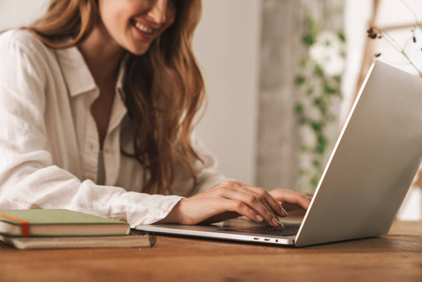 Business woman sit indoors in office using laptop computer. - Foto, imagen
