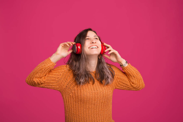 Photo of cheerful young woman, enjoying listening music at headp - Zdjęcie, obraz