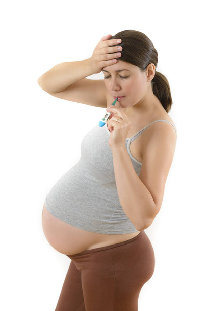 Pregnant Woman using Digital Thermometer - Photo, Image