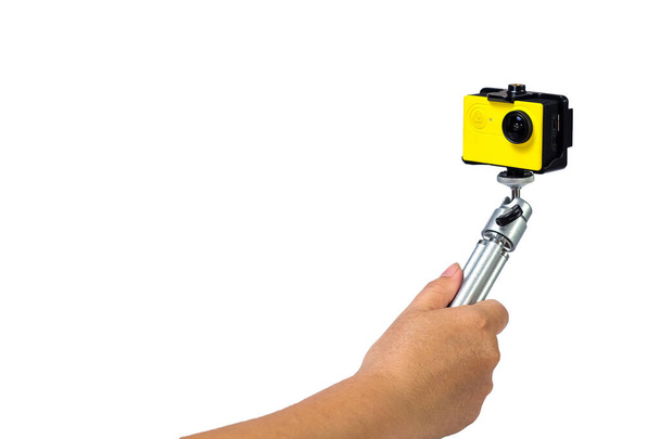 Action camera on mini tripod in hand with white background. - Foto, Imagen