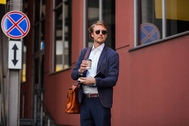 Attractive Man In Formal Clothes And Sunglasses Is Enjoying His Coffee Outdoors Near The Office - Fotografie, Obrázek