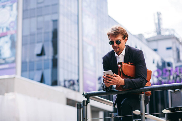 A Young And Handsome Businessman Works On The Go On His Phone - Valokuva, kuva