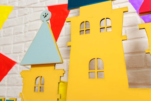 Details of the toy castle close-up. Toy castle is the backdrop for a photo shoot for a birthday. Photo zone with decorations for the birthday celebration for kids. Children's photo Studio for kids. Cardboard colorful children's castle - 写真・画像
