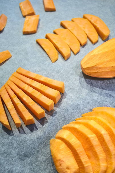 Fresh sweet potatoes on baking paper. - Fotó, kép