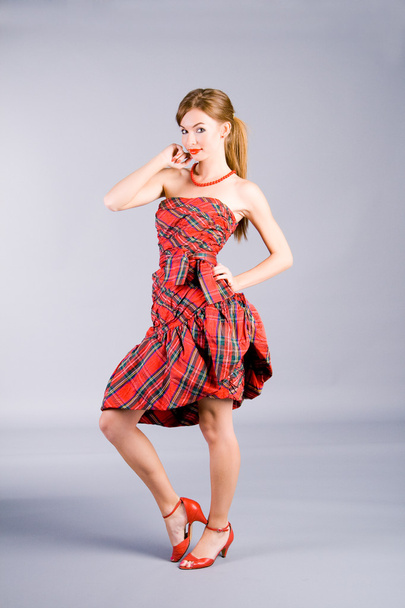 Stanting girl in red dress - Foto, immagini