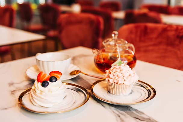 Thé avec dessert, table servie dans un salon de thé confortable
 - Photo, image